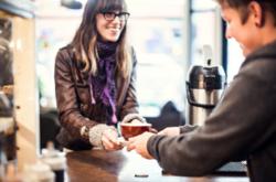 Handing over coffee in cafe